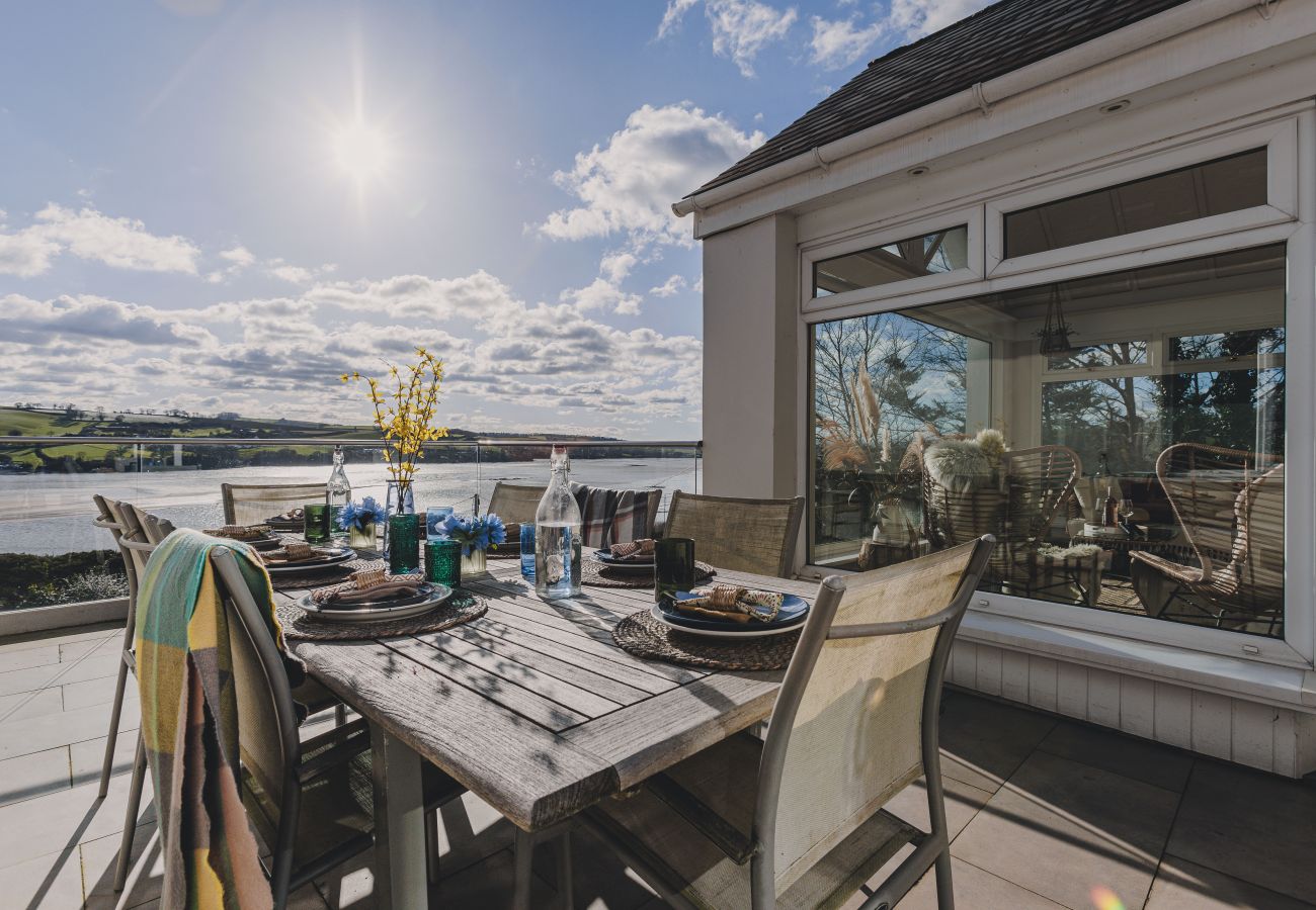 Private garden with entertainment deck, fire pit, and panoramic views of the Teign Estuary in a South Devon holiday home.