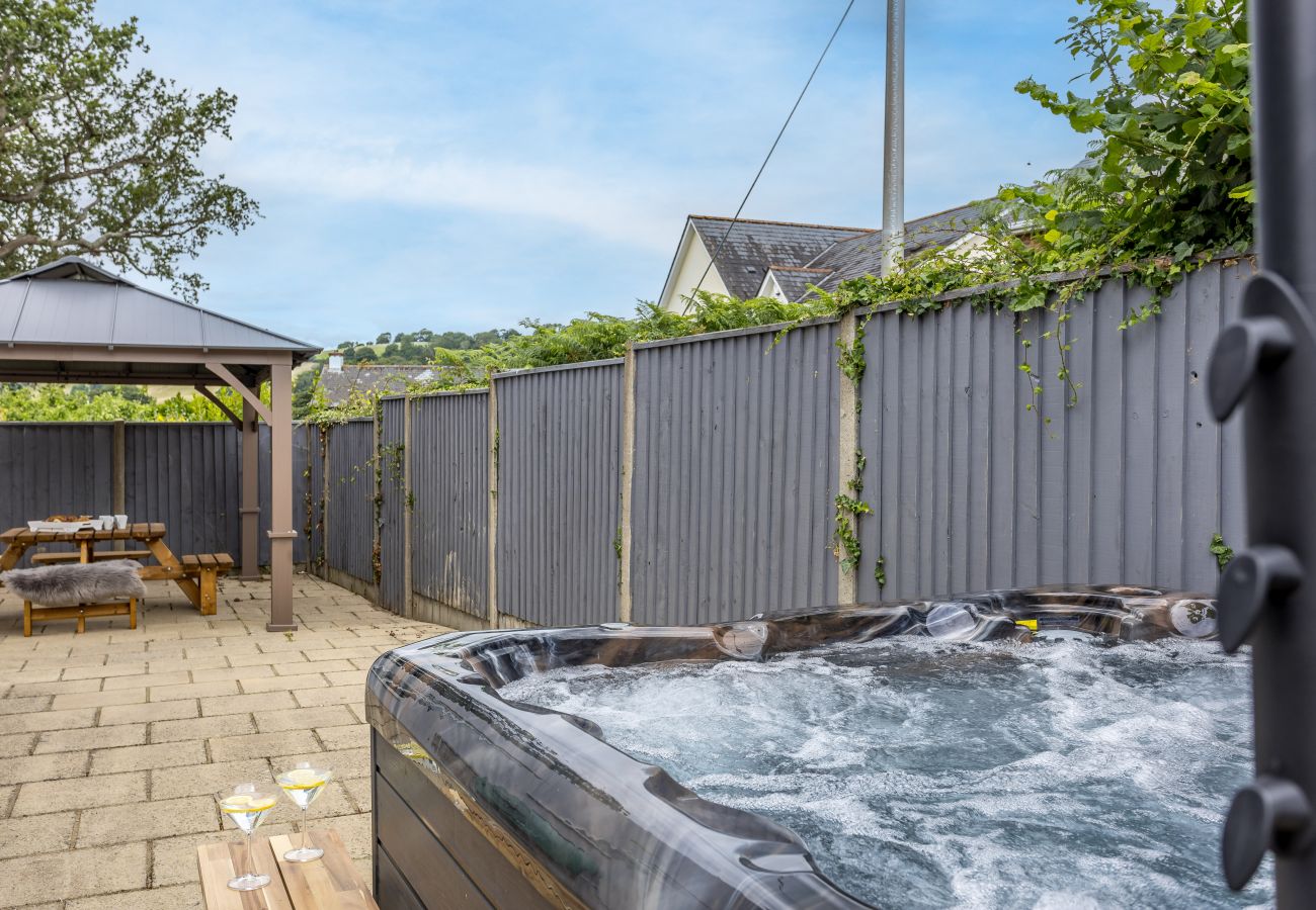 Private Hydropool spa and shaded pergola seating at a stylish South Devon holiday home.