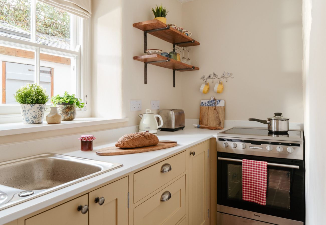 Well-equipped galley kitchen at a self-catering holiday cottage in South Milton, Devon.