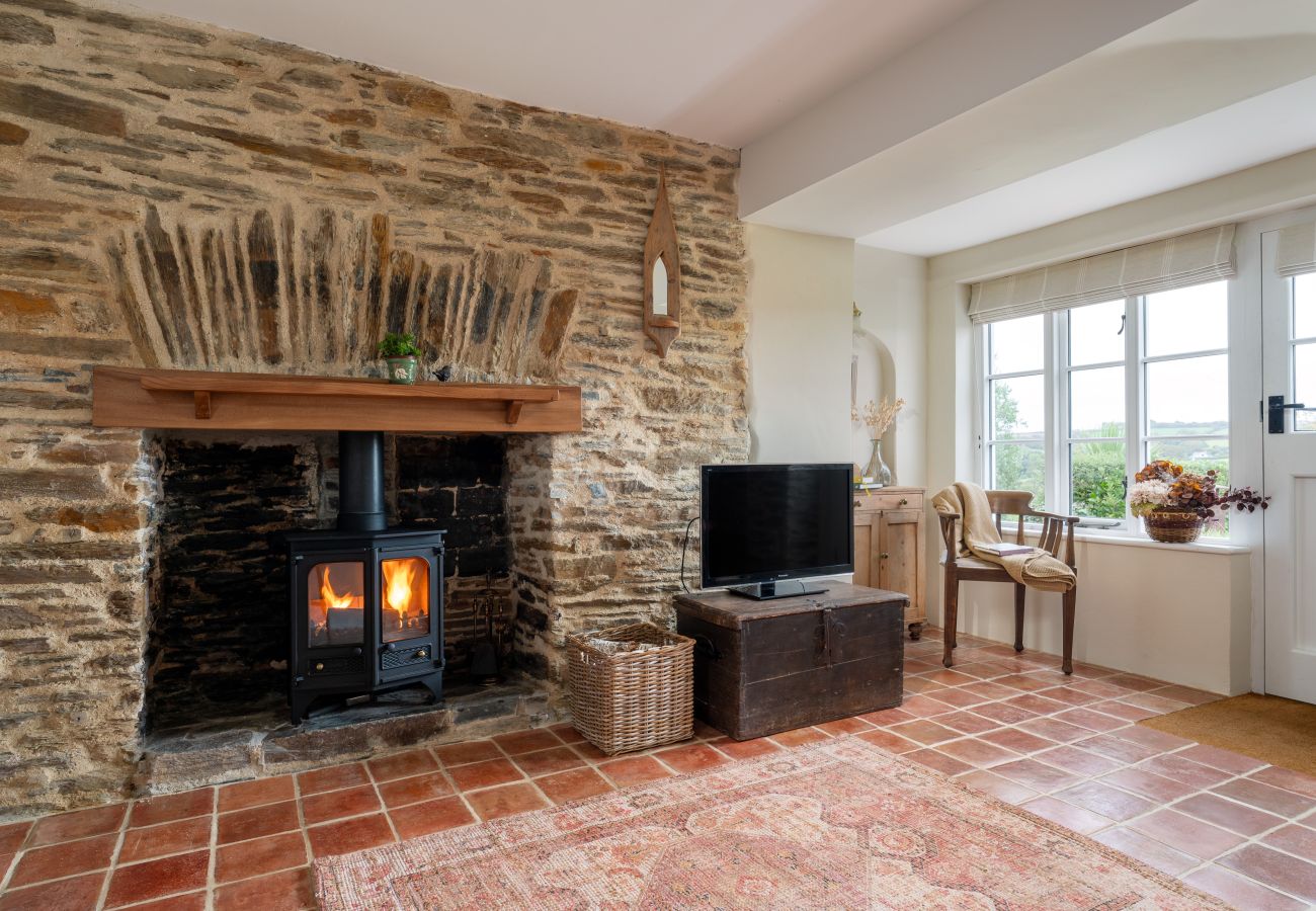Cozy living area with a wood burner at a romantic holiday cottage in South Milton, Devon.